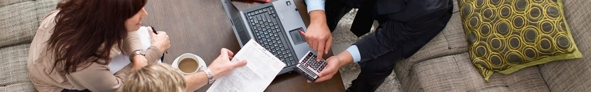 Woman talking to a man on a computer with calculator