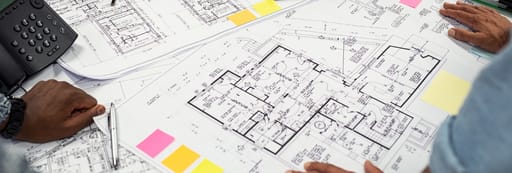 Architects working on blueprints