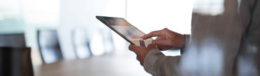 man holding mobile devices completing online transaction