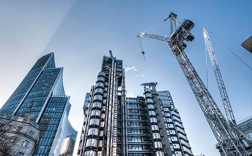 'Contemporary skyscrapers and construction site in London, financial district. Real sun beam.'