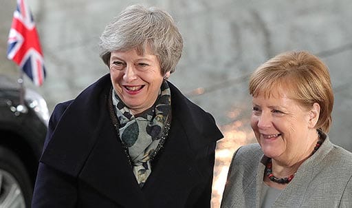 German Chancellor Angela Merkel walks with British Prime Minister Theresa May upon May's arrival for talks at the Chancellery on December 11, 2018 in Berlin, Germany