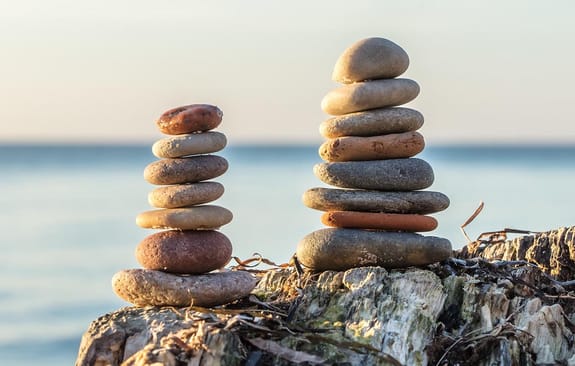 Two piles of perfectly balanced stones by the sea