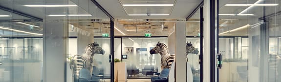 Statue of a zebra reflected in Investec's London office windows
