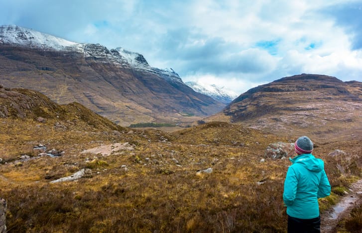 Woman stares out at a mountainous vista