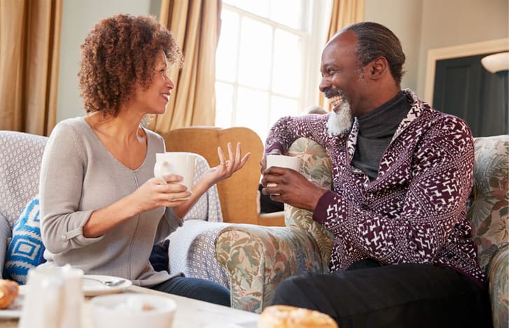 Middle-aged couple paint pottery together