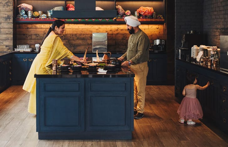 Family preparing a meal in modern kitchen