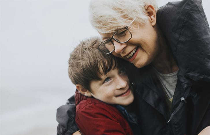 Women embraces her grandson in the cold