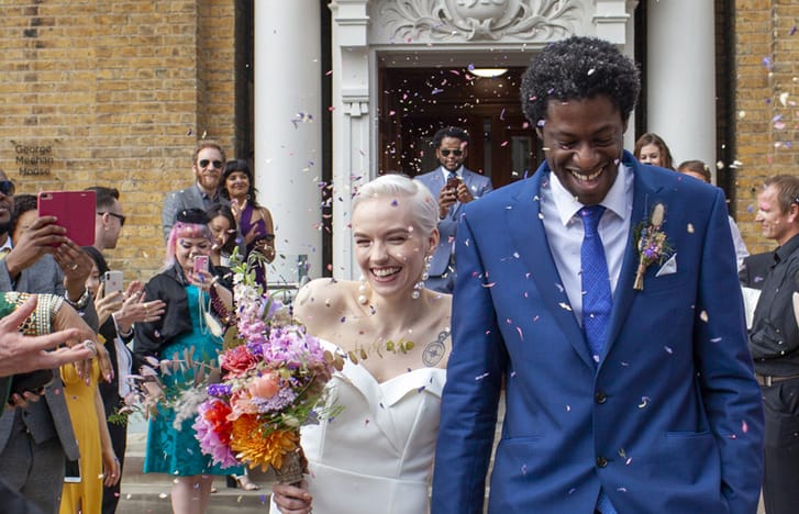 Newlyweds being celebrated walking out of wedding ceremony