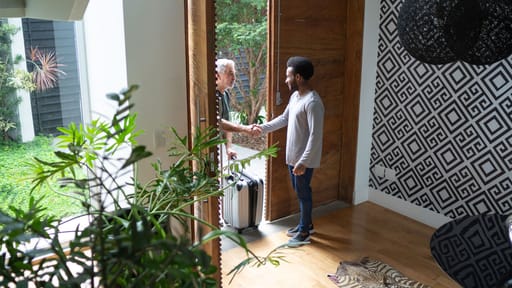 two people greating at the front door