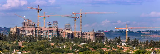 Multiple construction cranes at a building site