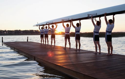 Rowing team facing lake