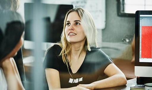 Woman at work speaking to colleague