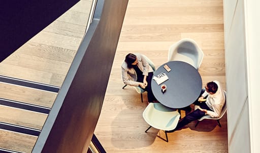 two people chatting across a table