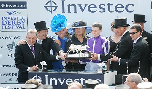 Joseph O'Brien, centre, flanked by owners Derrick Smith, Mrs. John Magnier and Michael B. Tabor, and Aidan O'Brien, celebrate with the trophy after winning the 2012 Investec Derby with Camelot