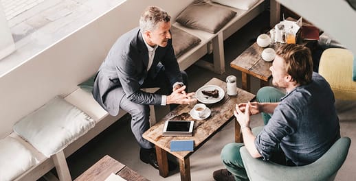 business people talking over coffee