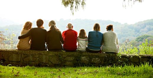 Family sitting on a low wall