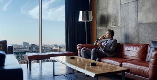 Business man on a couch looking out the window