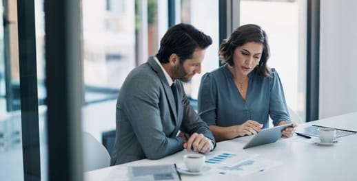 Business man and women looking at a laptop