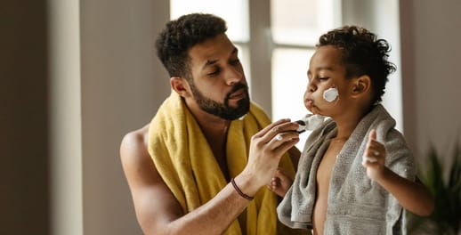 Father and son adding shaving foam