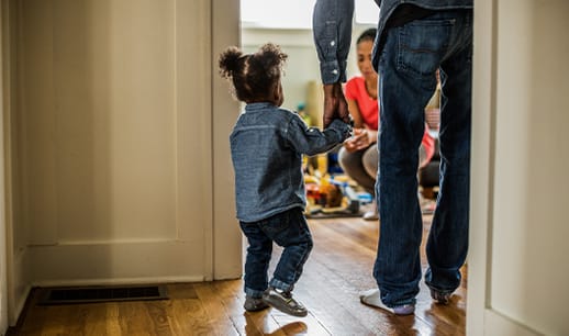 Dad walking his young daughter into a room
