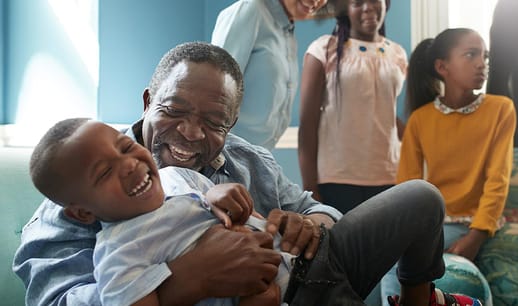 Grandpa tickling his grandson