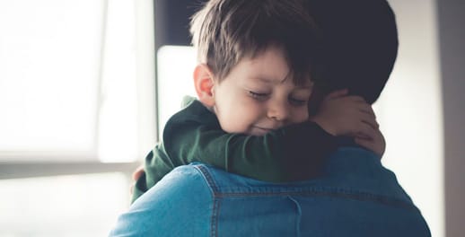 Young boy hugging his dad