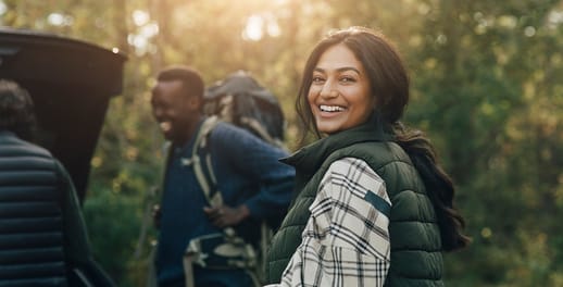 female smiling while with friends treking