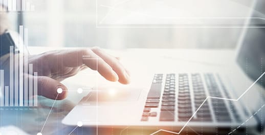 Person working at laptop with translucent bar chart overlay