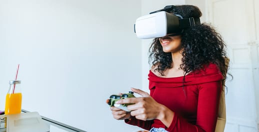 Female wearing a VR headset while playing computer game