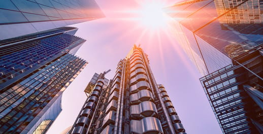 Looking up at office buildings with sunset