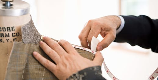 A tailor making a coat