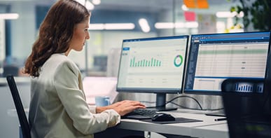 Female working at two monitors
