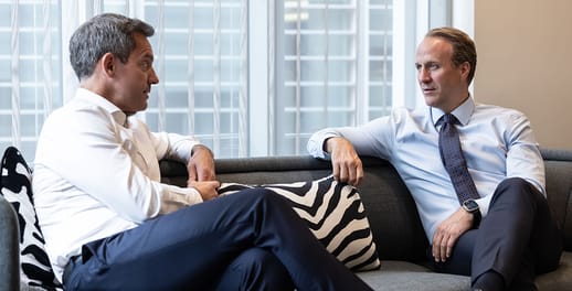 Private equity advisers chatting on a sofa