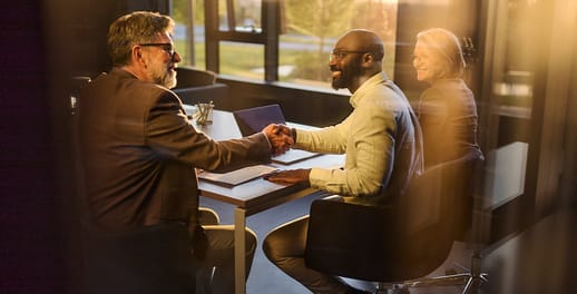Business men shaking hands in meeting