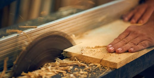 Wood being cut on rip saw