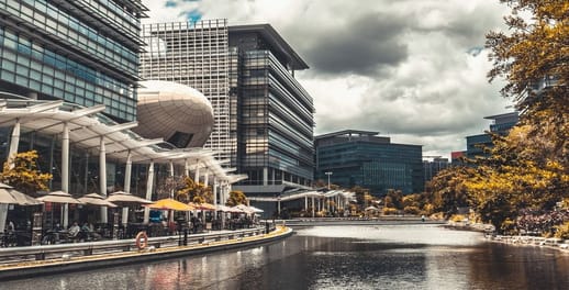 Apartments sit above restaurants lining a river