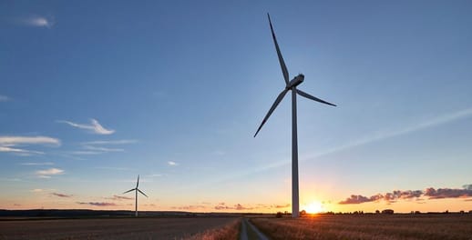 Wind turbines spinning at sunset