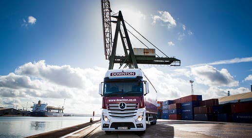 Image of a Downton lorry being loaded at a port by a crane