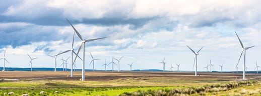 A landscape with wind turbines turning in the breeze