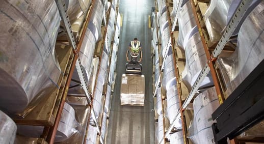 Image of electric jack operator moving boxes in a warehouse