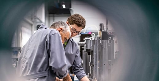 Two men working on machinery