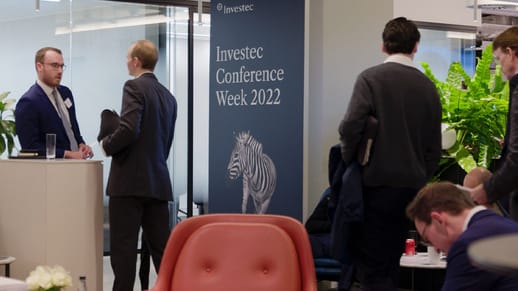 Investec Best Ideas Conference 2022 business men chatting in waiting area