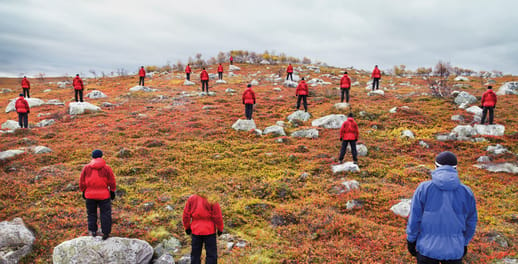 A group of walkers hiking across moorland on a cloudy day