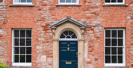 A view of the front door and windows of a detatched Edwardian house