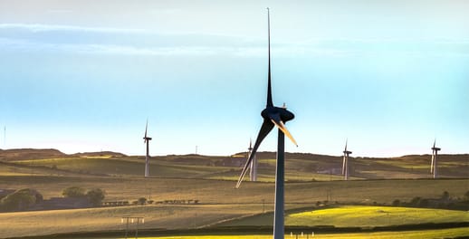 A view of wind turbines turning in the British countryside