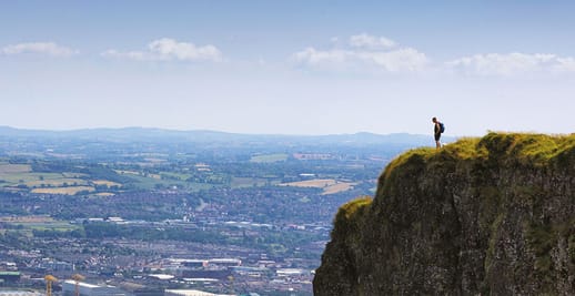 person standing at the top of a cliff 