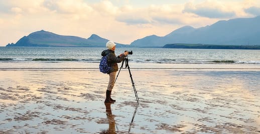 person with a camera on a beach