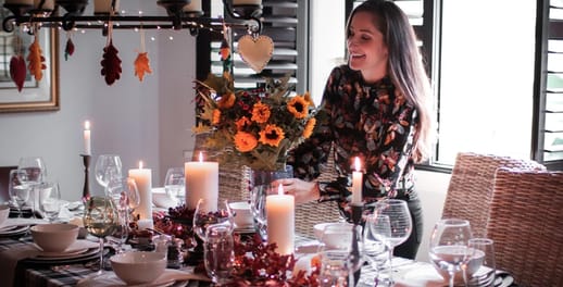 A woman setting the table for a dinner