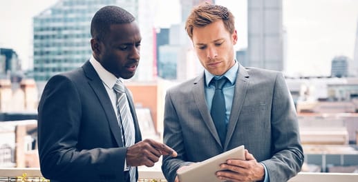 Two businessmen looking at a tablet