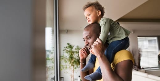 Man with young child on his shoulders